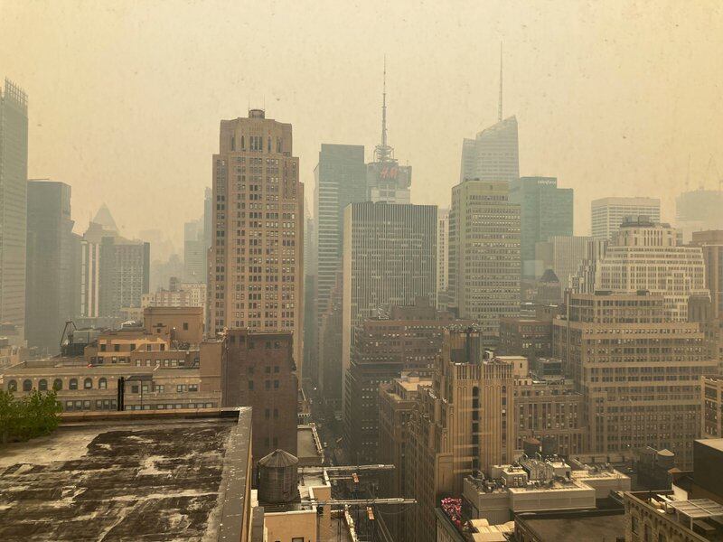 The Midtown Manhattan skyline looks yellowish-brown because of air quality issues.