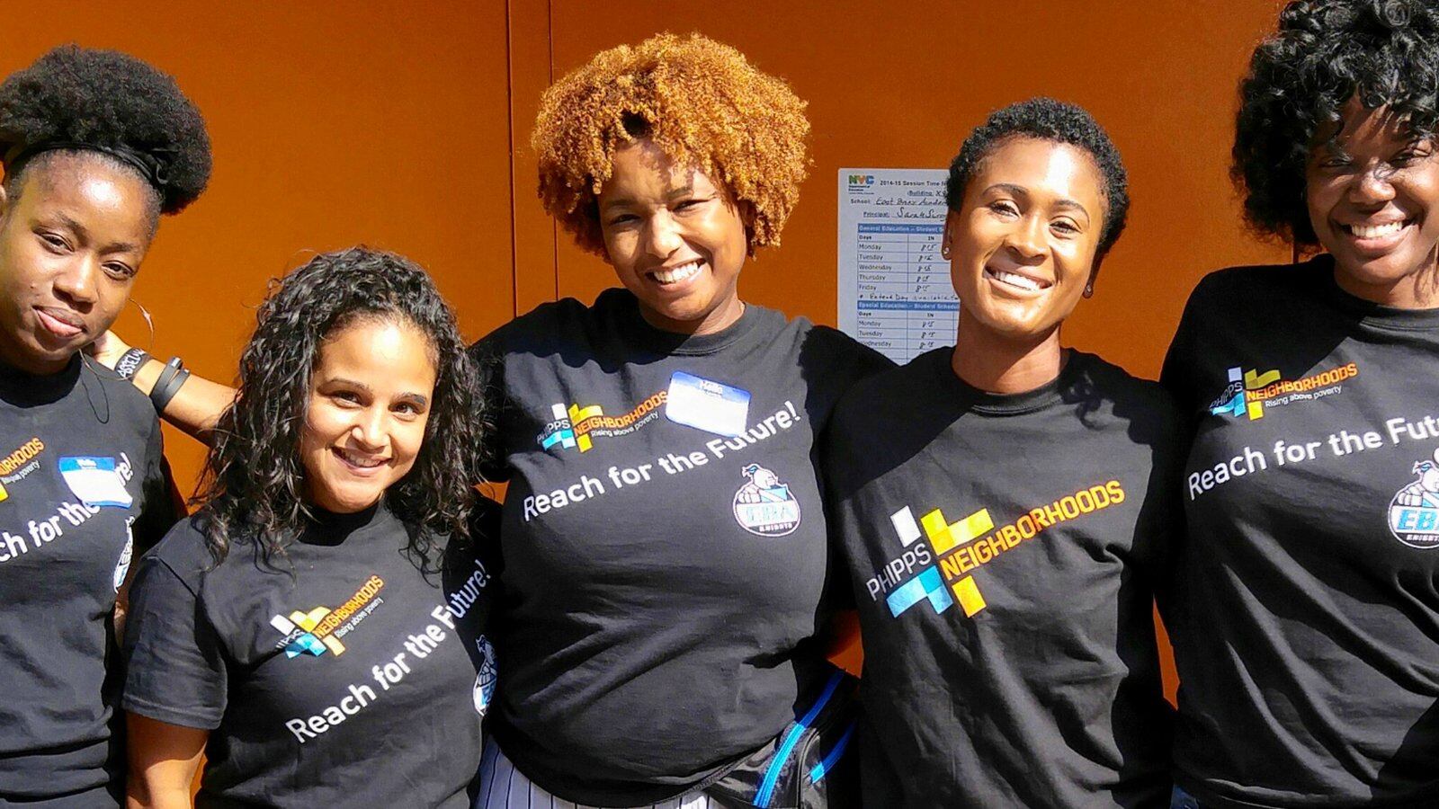 Perquida Payne (center) with colleagues. Payne is the community school director at the East Bronx Academy of the Future.