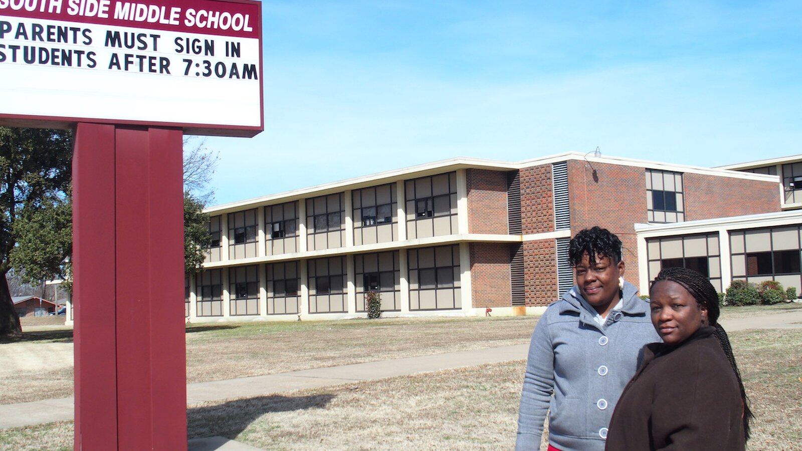 From left: Parents Charlotte Smith and Nadia Holmes stand in front of South Side Middle before the South Memphis school  was shuttered in 2015. The decision by leaders of Shelby County Schools impacted 300 students.