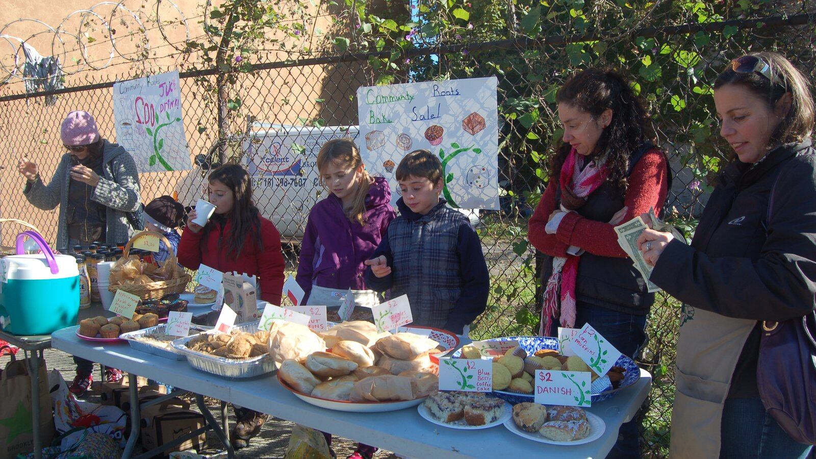 Families from Community Roots Charter School in Brooklyn hold a bake sale.