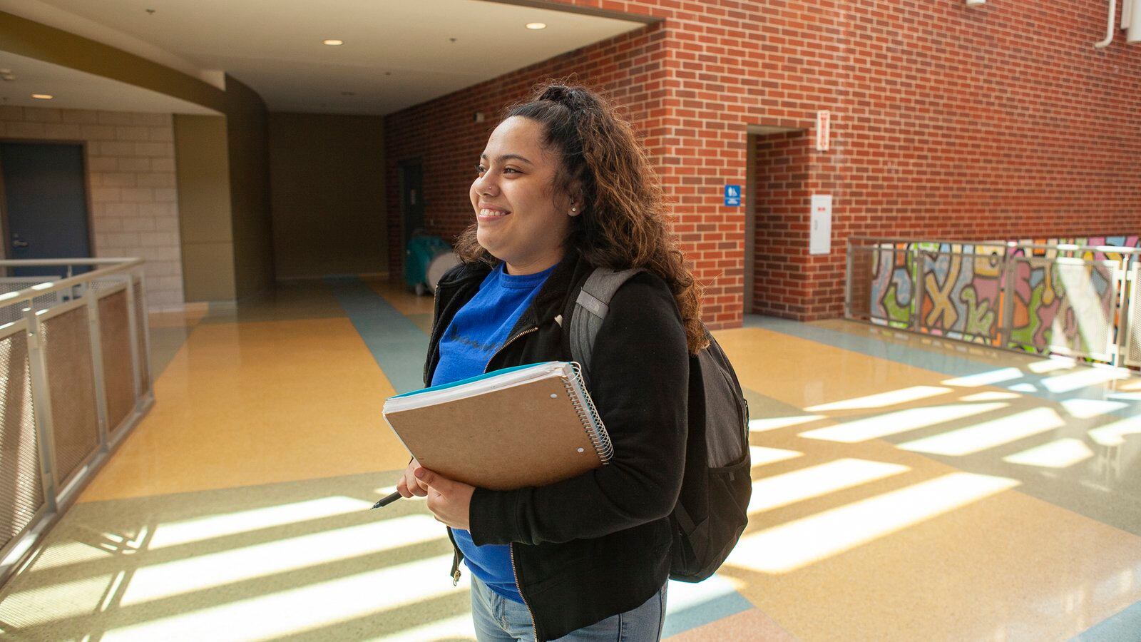 Itzayanna walks in the hallway at North Grand High School in Chicago. Photo by Stacey Rupolo/Chalkbeat; taken May, 2019