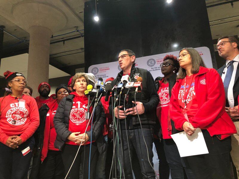 Chicago Teachers Union chief Jesse Sharkey, stands with union leaders after a House of Delegates vote to accept a tentative contract, Oct. 30, 2019.
