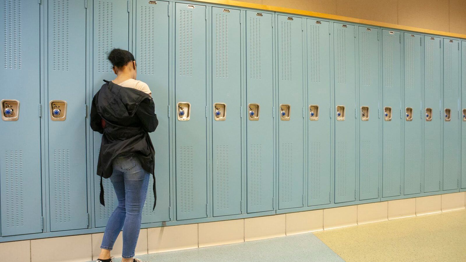 A student at her locker in a hallway at North-Grand High School in Chicago. Photo by Stacey Rupolo / Chalkbeat —May, 2019 photo—