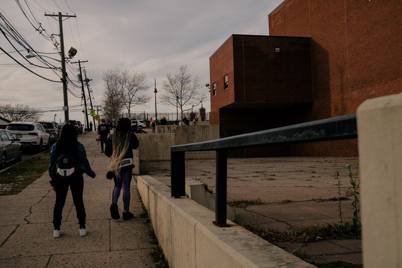 Students wait outside of Malcolm X Shabazz High School to head home after the school day.