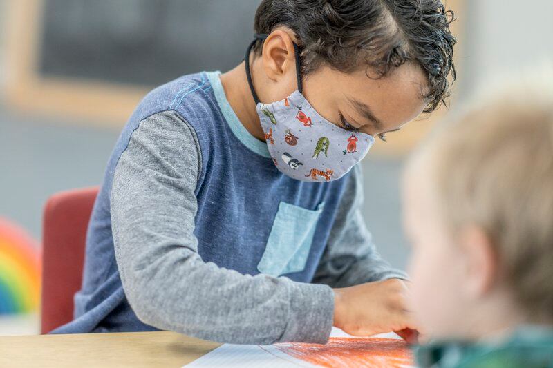 A child in a mask at a day care center