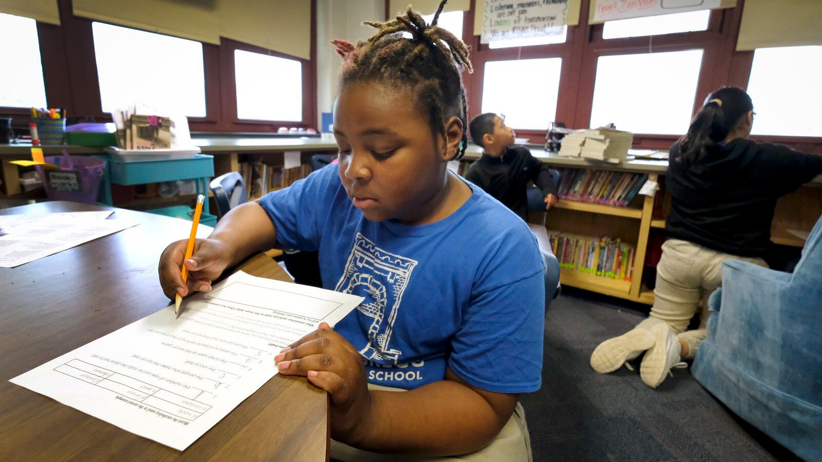 A student with a pencil works at a desk in a classroom at Thomas Gregg Neighborhood School, an elementary school in Indianapolis, Indiana.