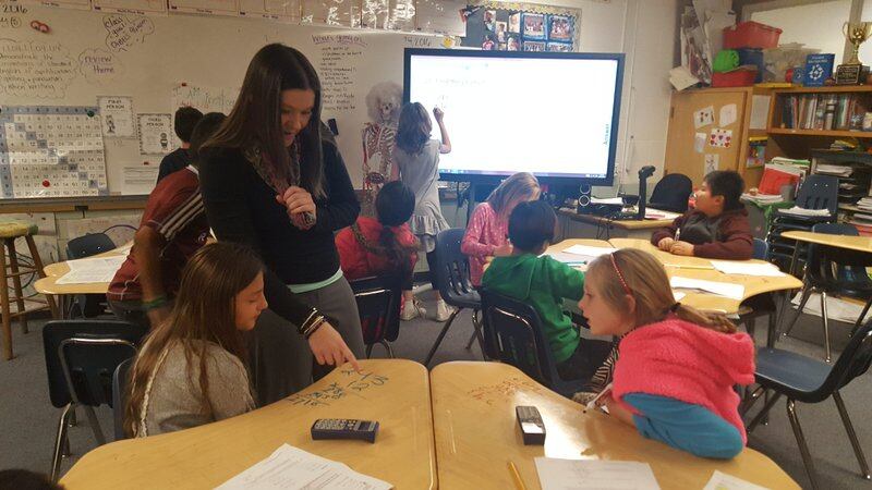 Teacher Amy Adams walks around her classroom checking on students working independently on math at Flynn Elementary School in Westminster. (Photo by Yesenia Robles, Chalkbeat)