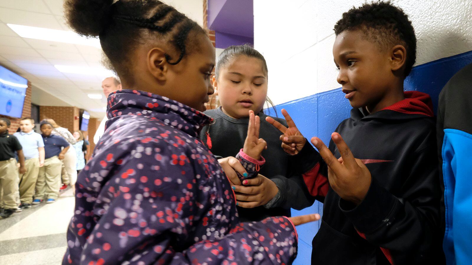 Students interact with one another before class at Thomas Gregg Neighborhood School, an elementary school in Indianapolis, Indiana.
