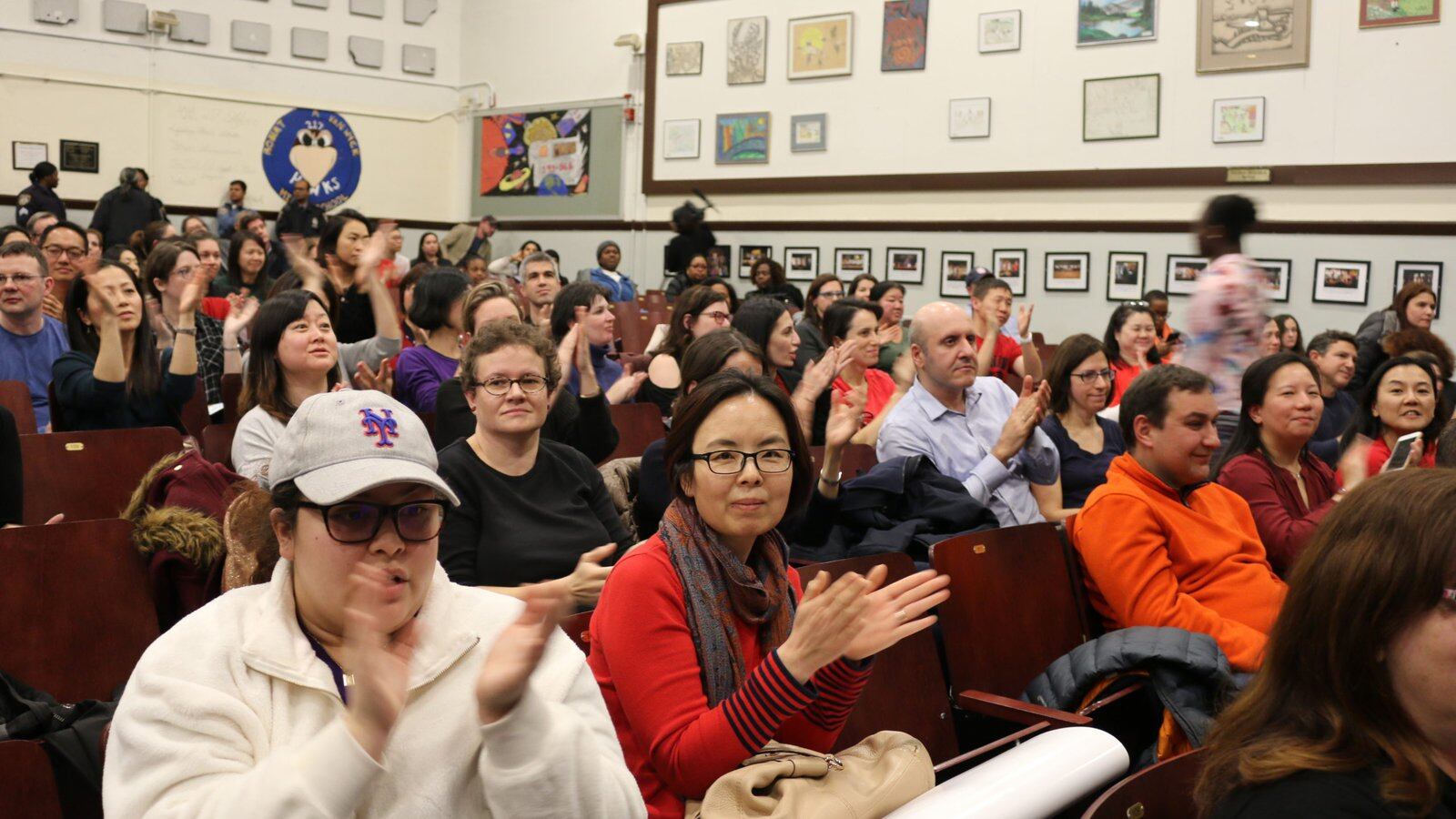 Parents in January 2020 applaud a speaker during a contentious meeting to discuss middle school integration plans for District 28 in Queens. Fights how to make New York City schools more representative of student demographics have filtered down to the races to elect Community Education Council members.