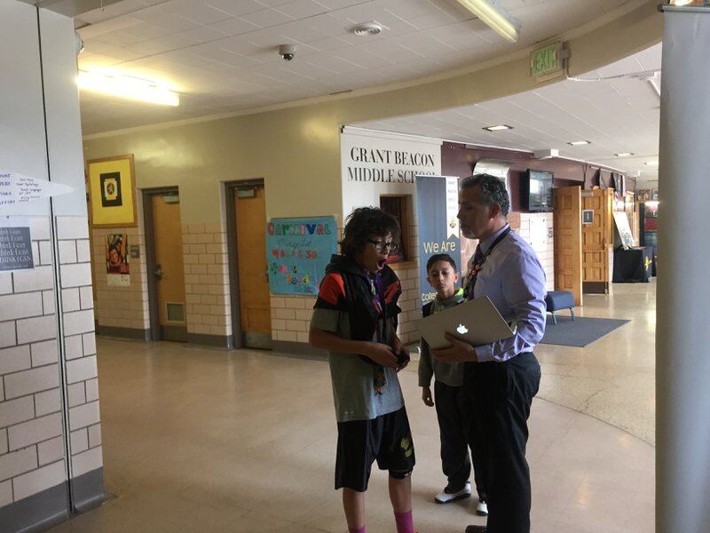 Alex Magaña, then principal at Grant Beacon Middle School, greeted students as they moved between classes in 2015.