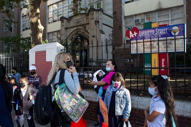 Several students and parents make their way into Newark’s Lafayette Street School on the first day of classes.