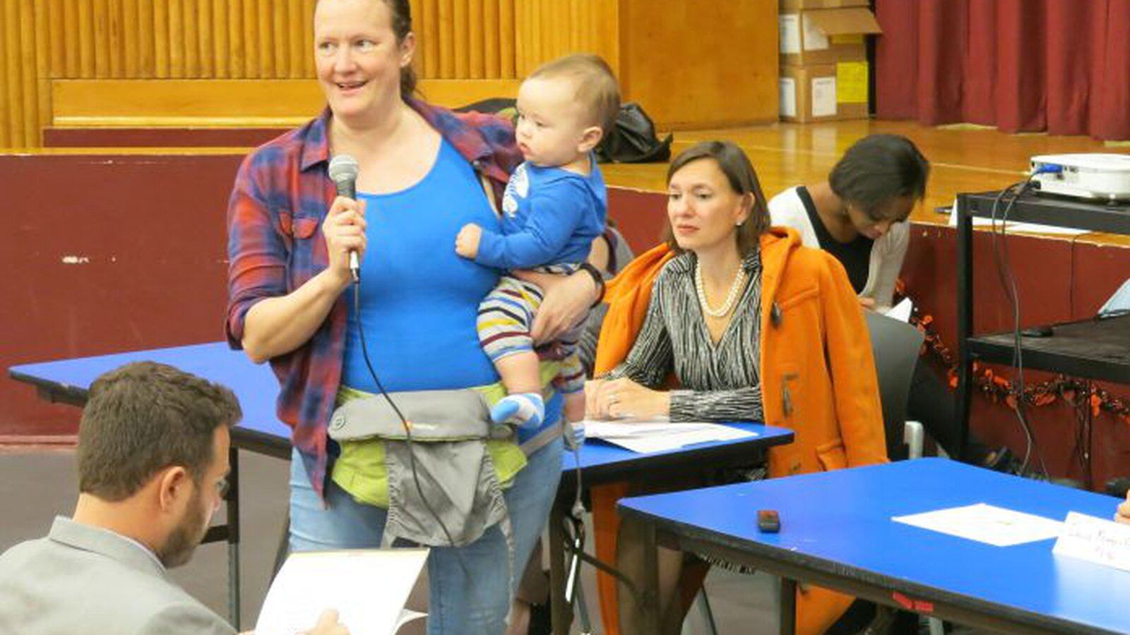 Carole-Ann Moench, a teacher at Global Neighborhood Secondary School, expresses her reluctant support for a plan to merge the school with P.S. 96. To the right is Deputy Chancellor of Operations Elizabeth Rose. ( Photo by Geoff Decker )
