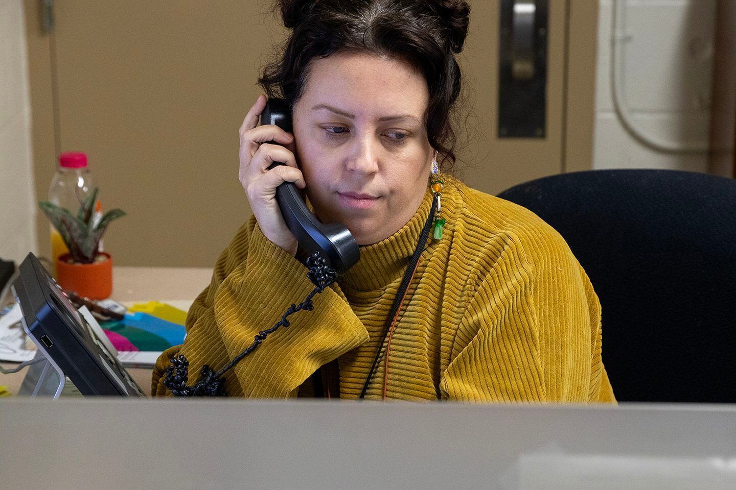 Megan Rahill, a shelter and housing specialist for Cincinnati Public Schools, calls a family in her office at Project Connect.