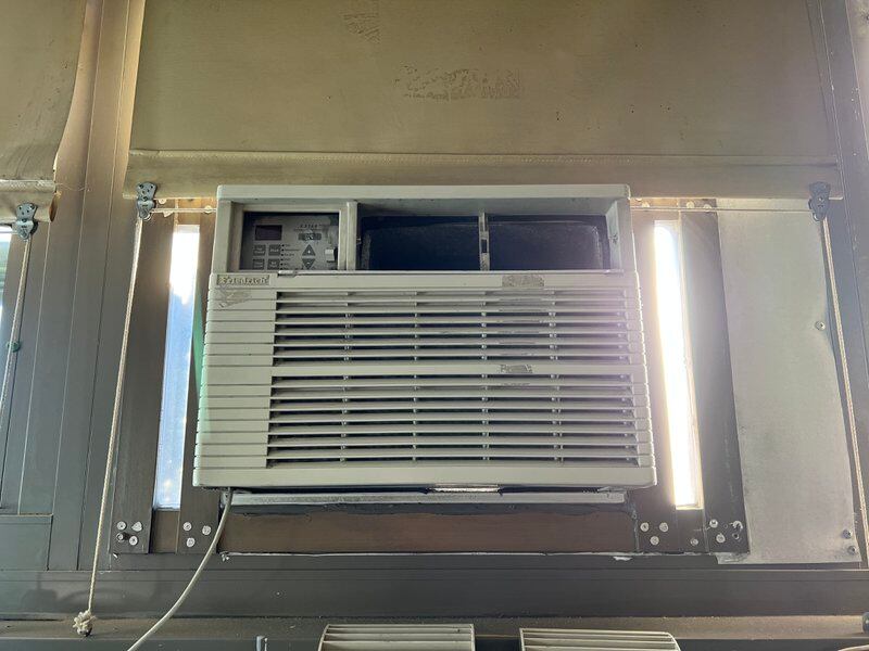 A close up of a wall air conditioning unit.