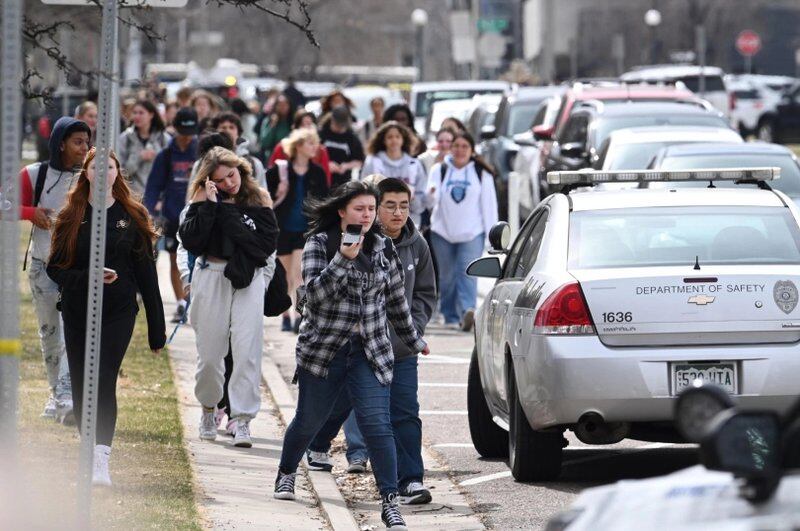 Students leave Denver’s East High School after a shooting there on Wednesday, March 22, 2023.