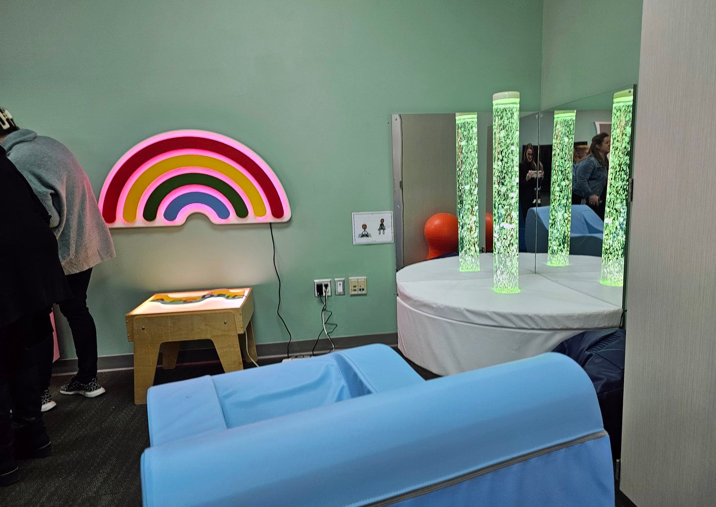 A room with blue walls and different sensory learning tools.