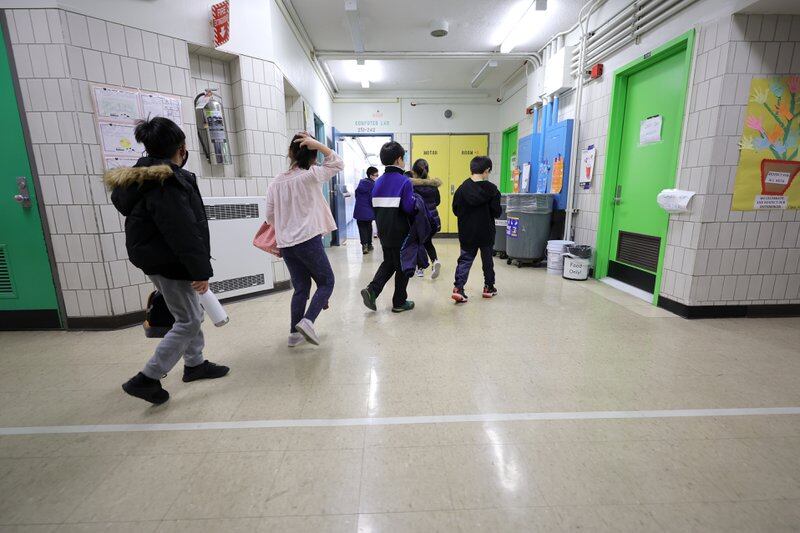 Students are led to their classroom by a teacher at New York City school. State officials want to remove the designation of “emotional disturbance” for students with disabilities, which affects about 8,400 city children.
