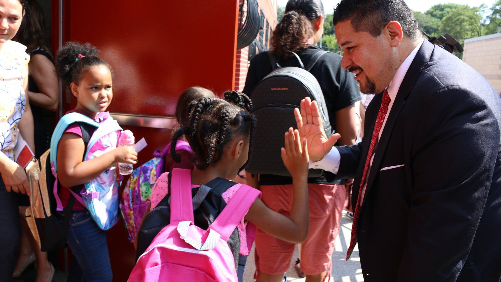 Schools Chancellor Richard Carranza high-fives students at P.S. 78 on Staten Island as they leave after the first day of the 2018-2019 school year.