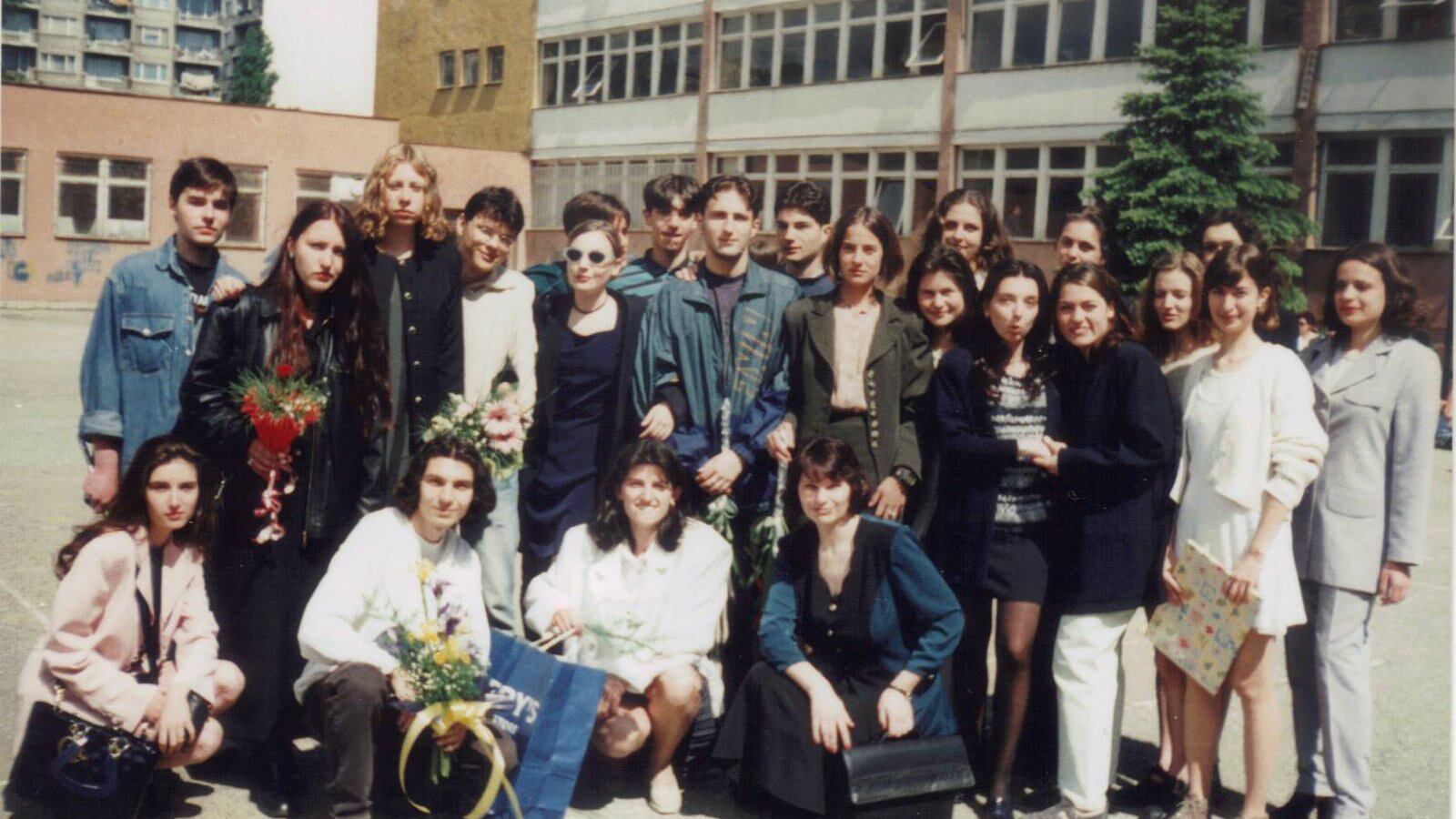 Chalkbeat Chicago reporter Mila Koumpilova (pictured second from right in a white dress) at age 18 with her class in front of her high school in Sofia, Bulgaria.