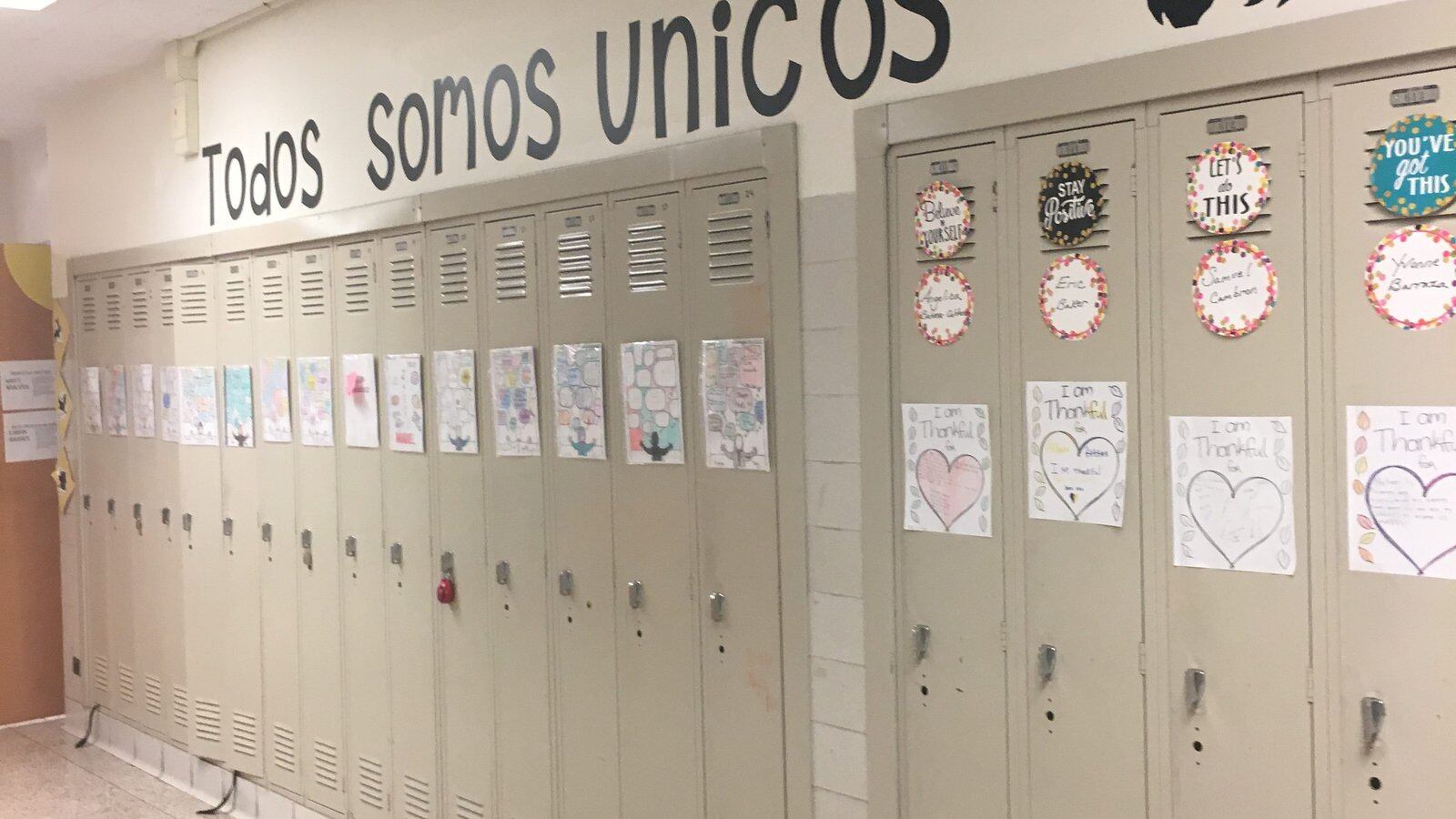 A messaging saying 'we are all unique' adorns a hallway at Belmont-Cragin Elementary, a dual-language school.