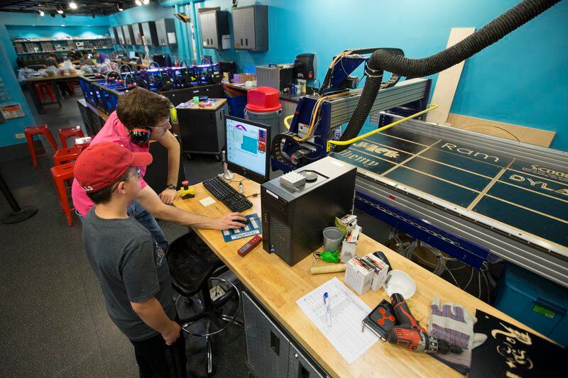 Two teens work on a “ShopBot” for computer-aided design and fabrication at Chicago’s Museum of Science and Industry.