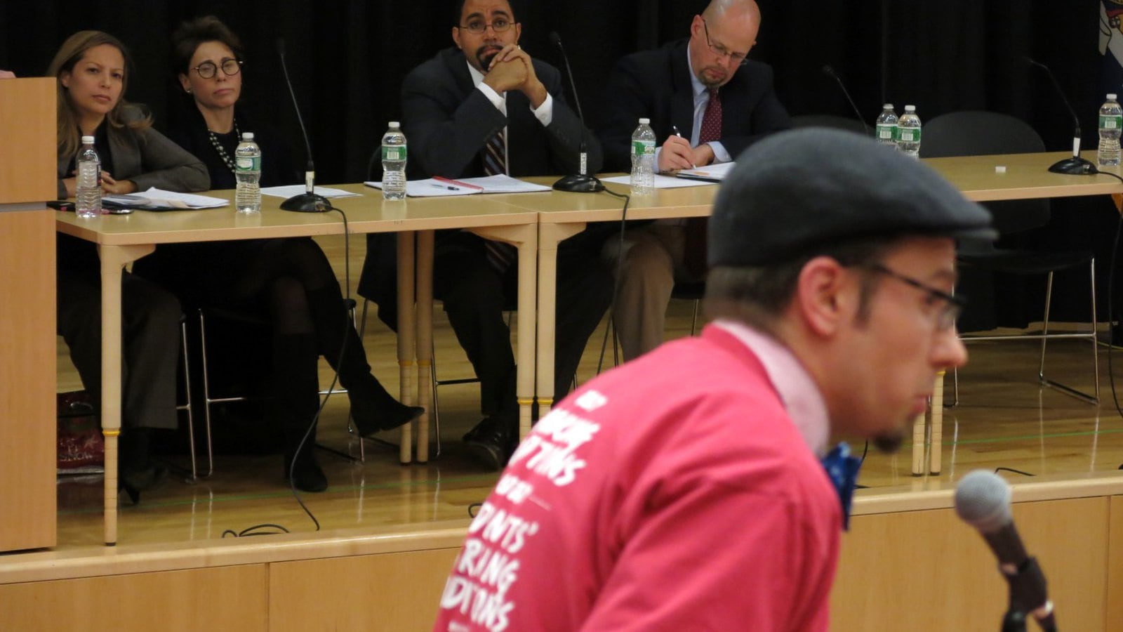 State Education Commissioner John King (center) listens to a critic during one of a series of heated Common Core forums last fall. Backlash against the new standards went mainstream this year.
