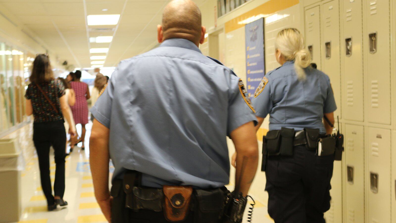 School safety agents walk the hallway at the James Monroe High School Campus Annex in the Bronx.