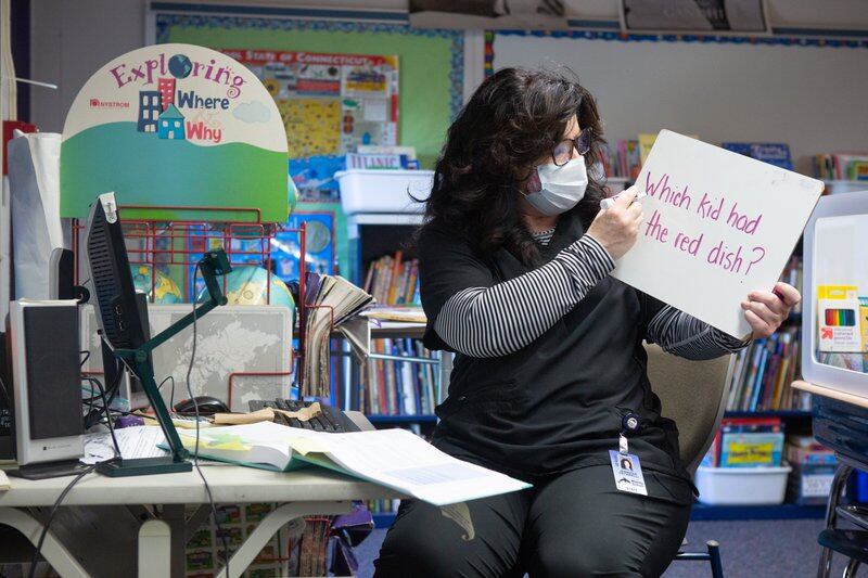 Second grade teacher Mrs. Cecarelli uses a white board to teach both her in-class and online students at Wesley Elementary School in Middletown, CT, October 5, 2020.