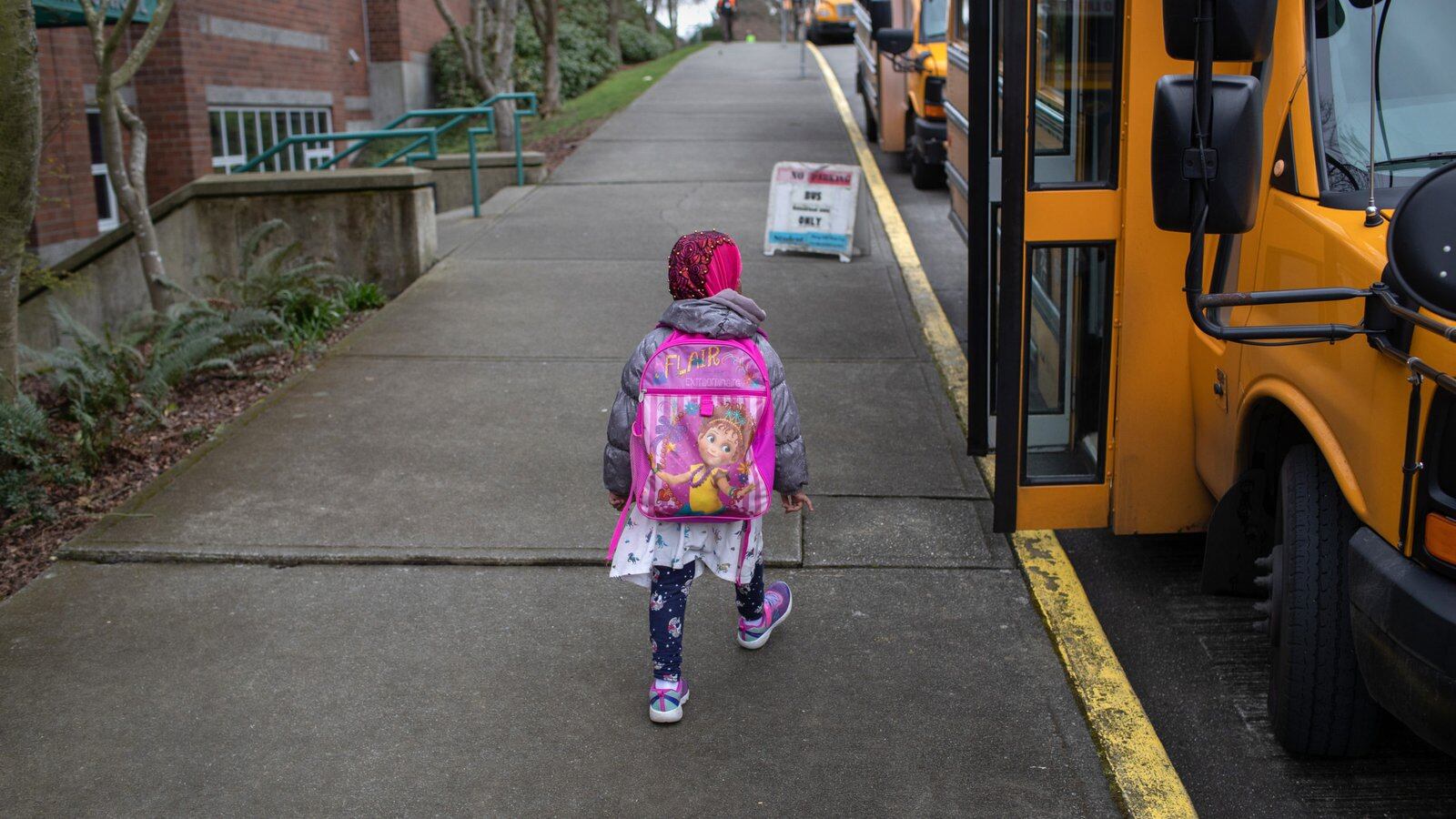 A student leaves a school in Seattle, where coronavirus fears have led to school closures. Across the country, the virus is prompting schools to rethink their attendance policies.