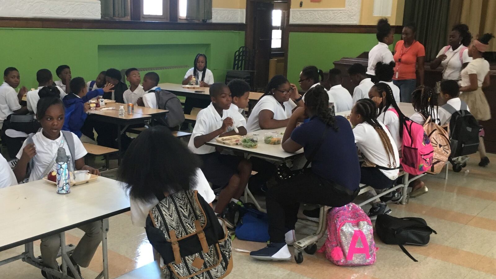 The cafeteria at the Golightly Education Center, above, is full on a normal school day. On Wednesday, the room sat empty because the Detroit district was closed due to an ice storm.