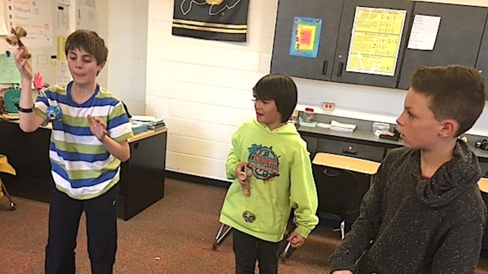 Students practice tricks during a recent Kendama Club meeting at Louisville Middle School