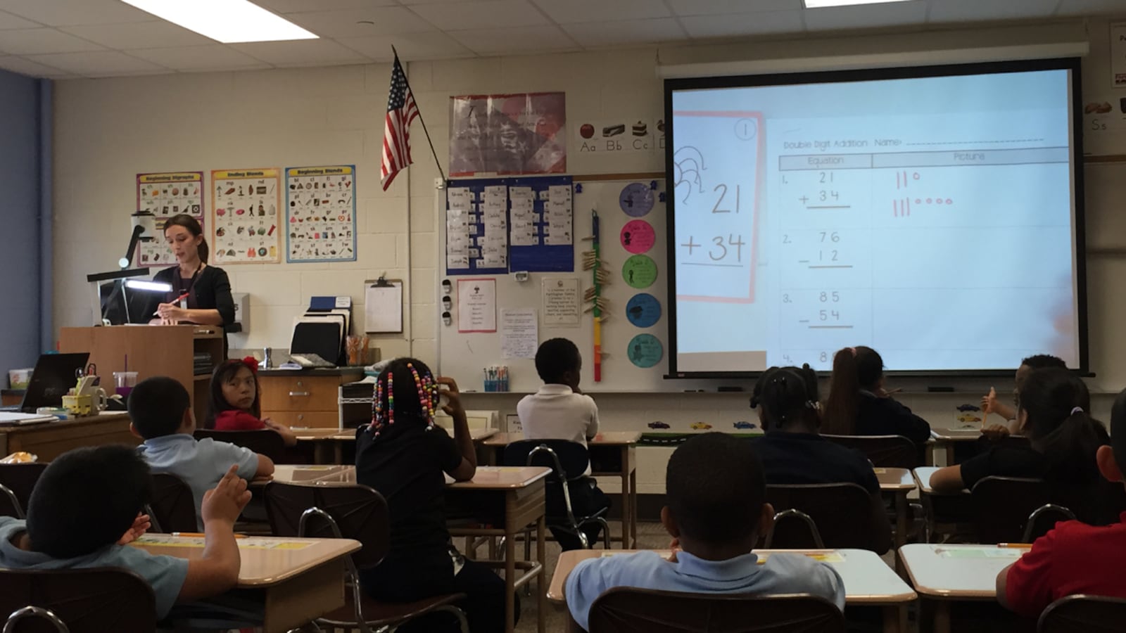 Natalie Shaw checks subtraction and addition problems with her second-graders at IPS School 61. The school is part of the district's pilot in racial equity training.