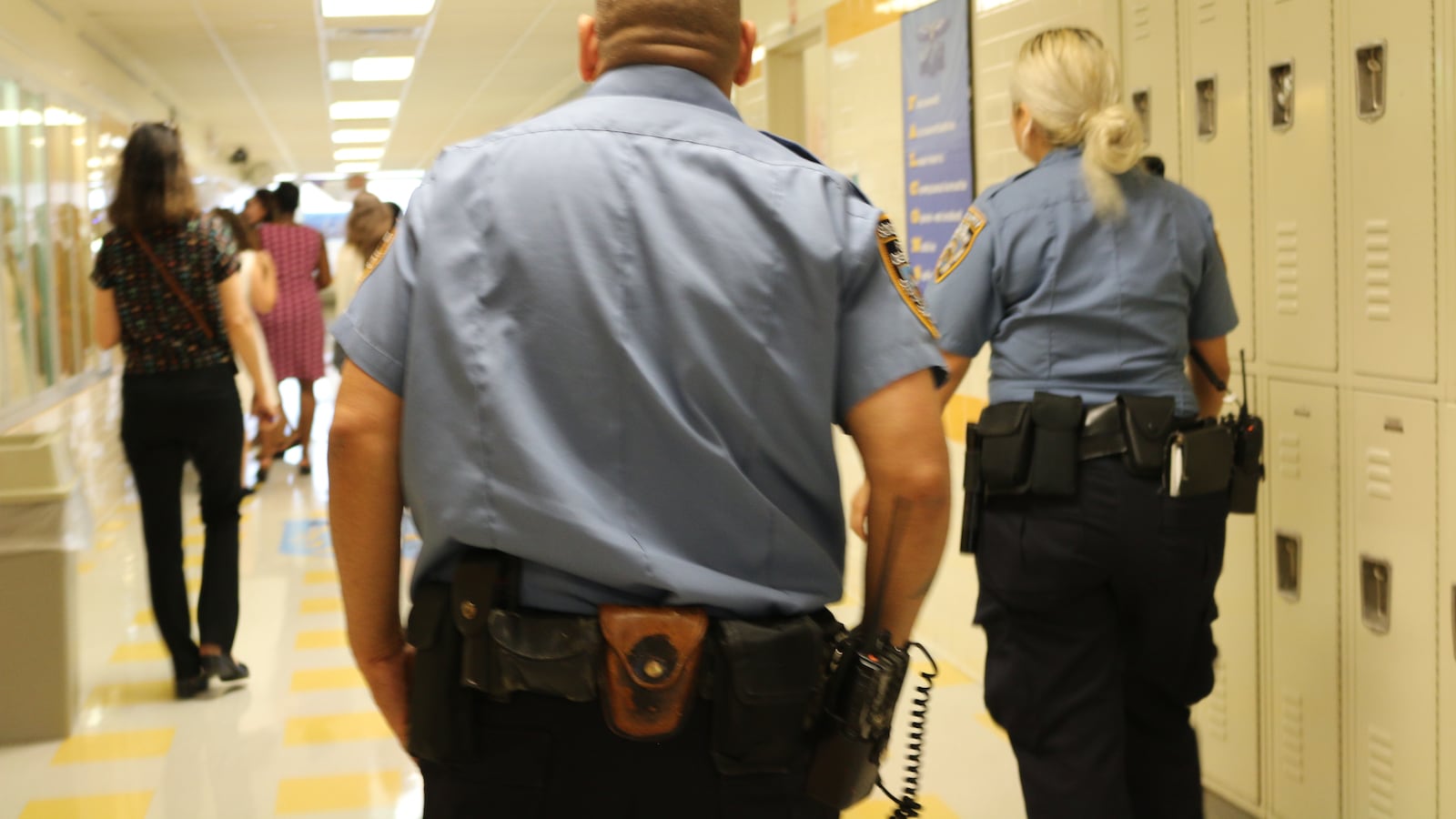 School safety agents walk the hallway at the James Monroe High School Campus Annex in the Bronx.