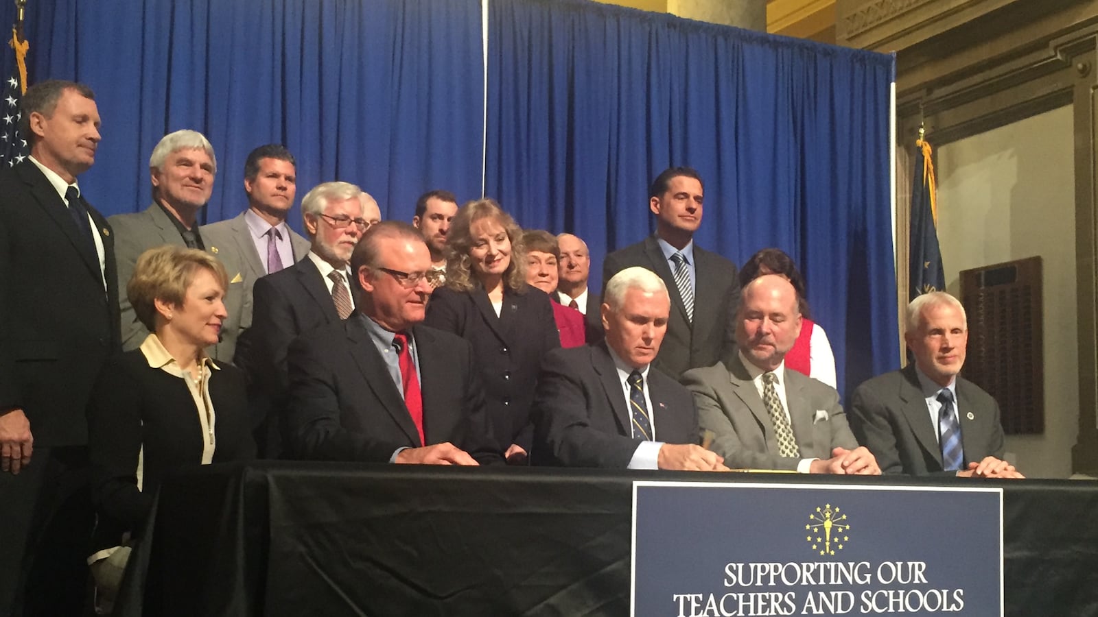 Gov. Mike Pence signs Senate Bill 200 and House Bill 1003, both with the goal to ease the consequences of ISTEP score drops on schools and teachers, into law.