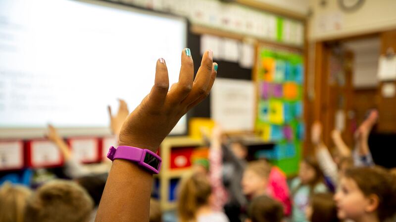 A second-grade student raises their hand at Denver’s Carson Elementary.
