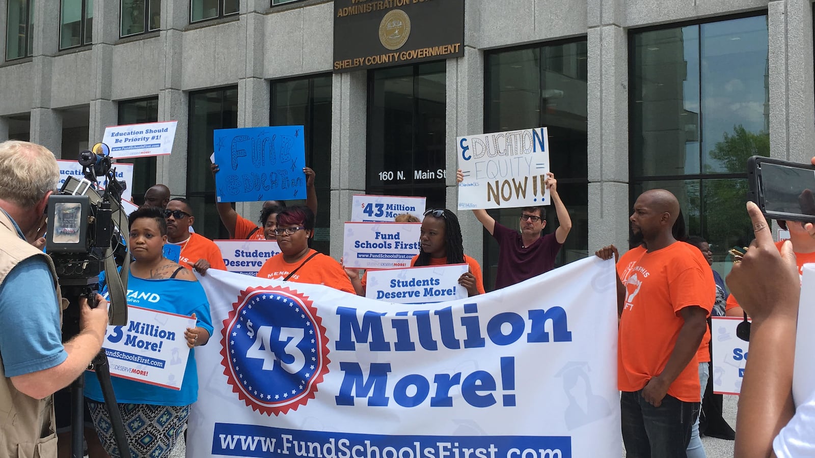 Education advocates rally outside of the building where Shelby County's Board of Commissioners meet to discuss funding for Shelby County Schools.