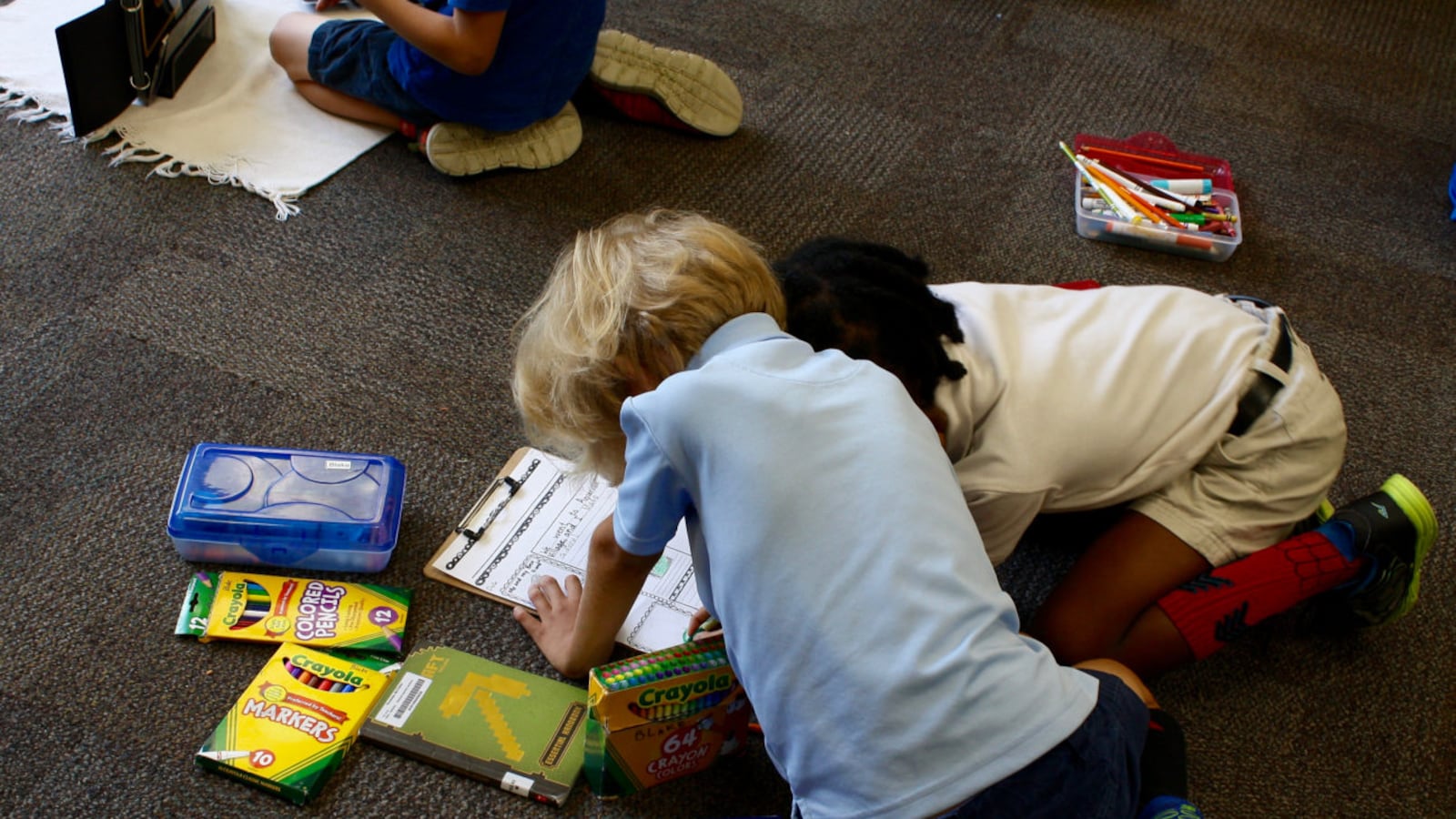 Together, two School 91 students work on reading and writing.