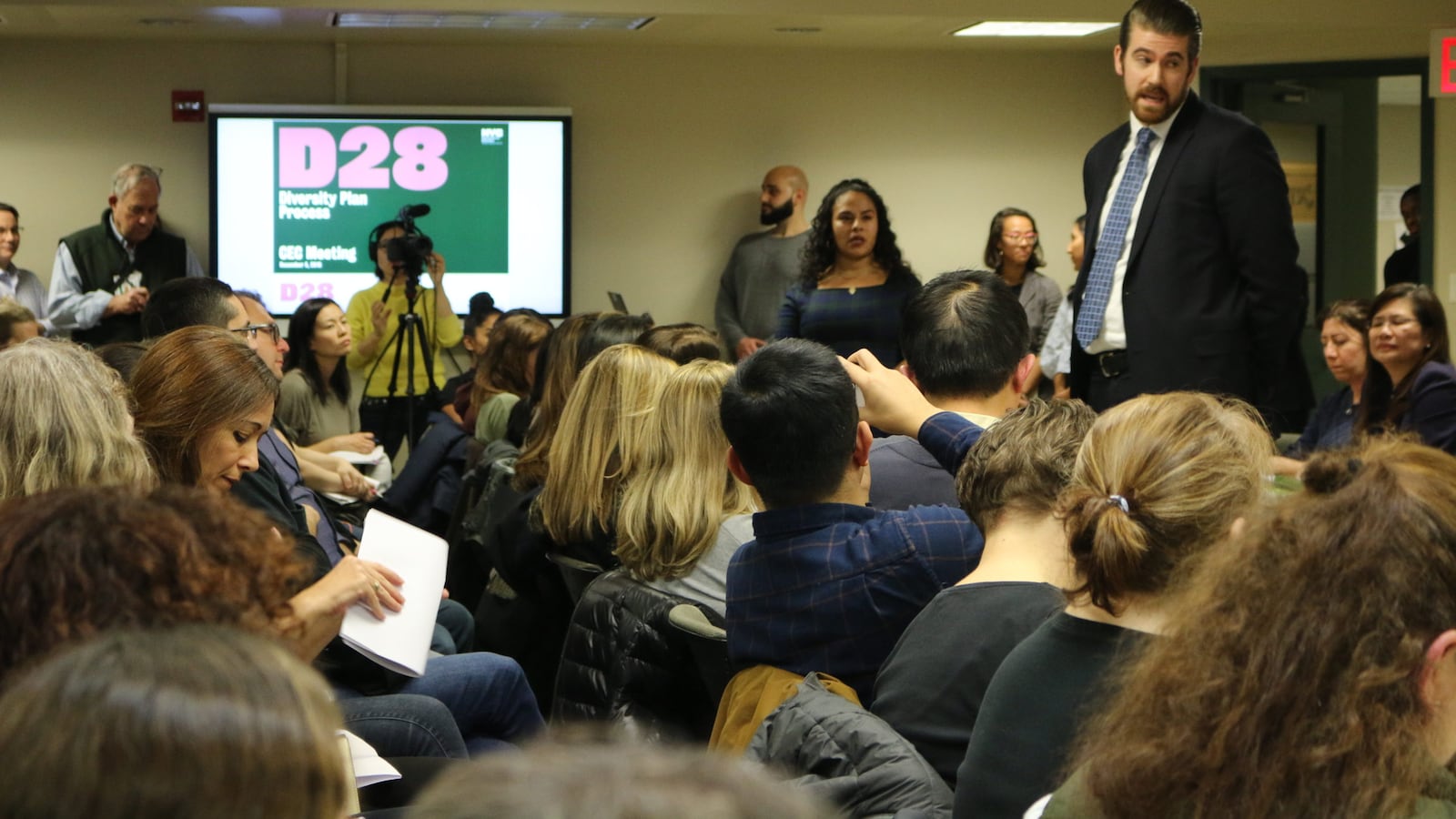 Education department officials took questions from parents regarding plans to integrate middle schools at a Community Education Council District 28 meeting in December 2019.
