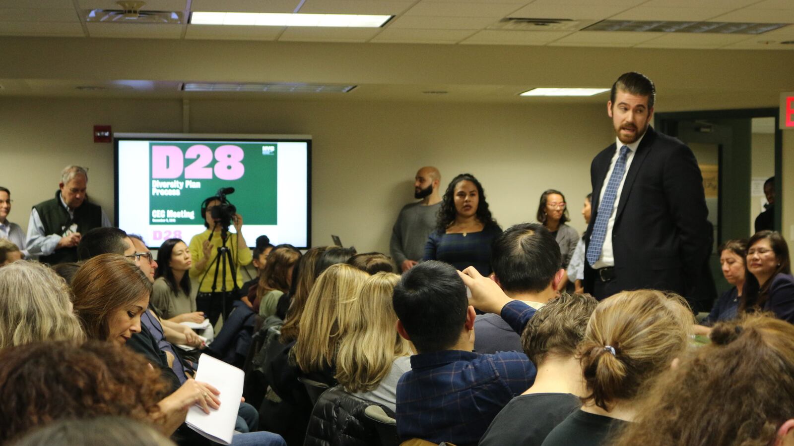 Education department officials took questions from parents regarding plans to integrate middle schools at a Community Education Council District 28 meeting in December 2019.