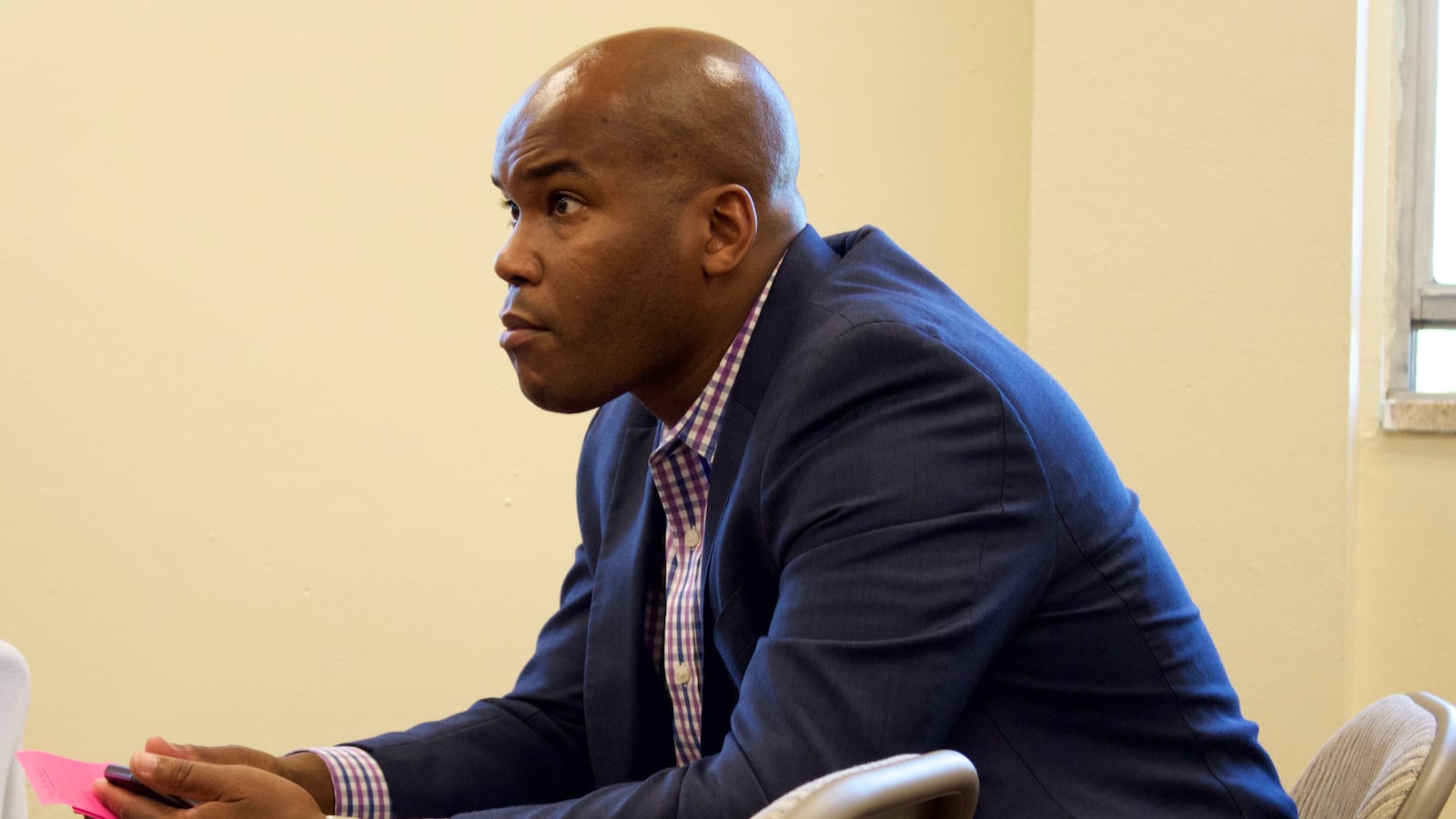 Lamont Browne listens to immigrant parents share their stories about Aurora Public Schools at a forum in June hosted by Rise Colorado.