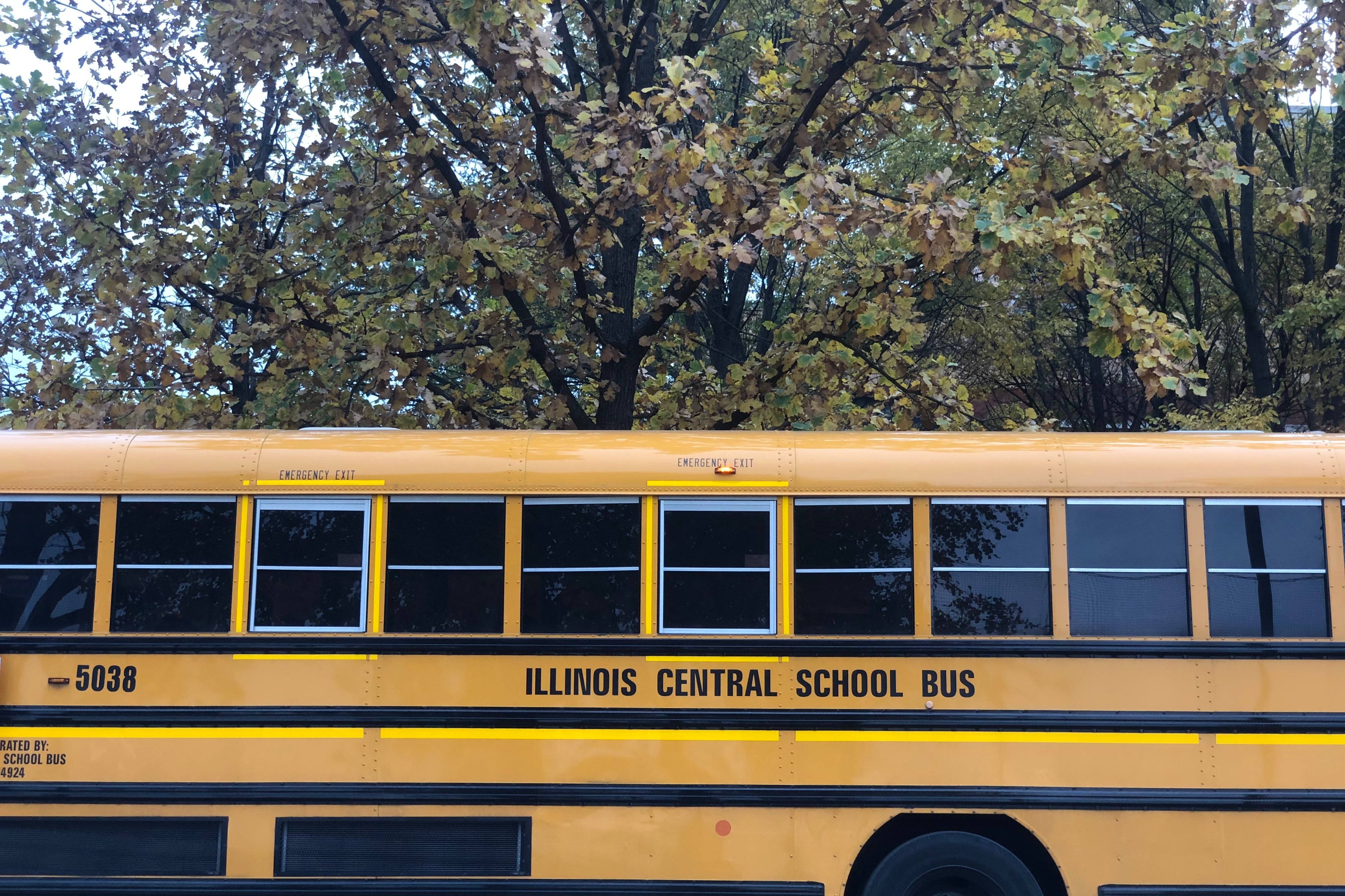 A yellow school bus sits outside a school on Chicago’s South Side.