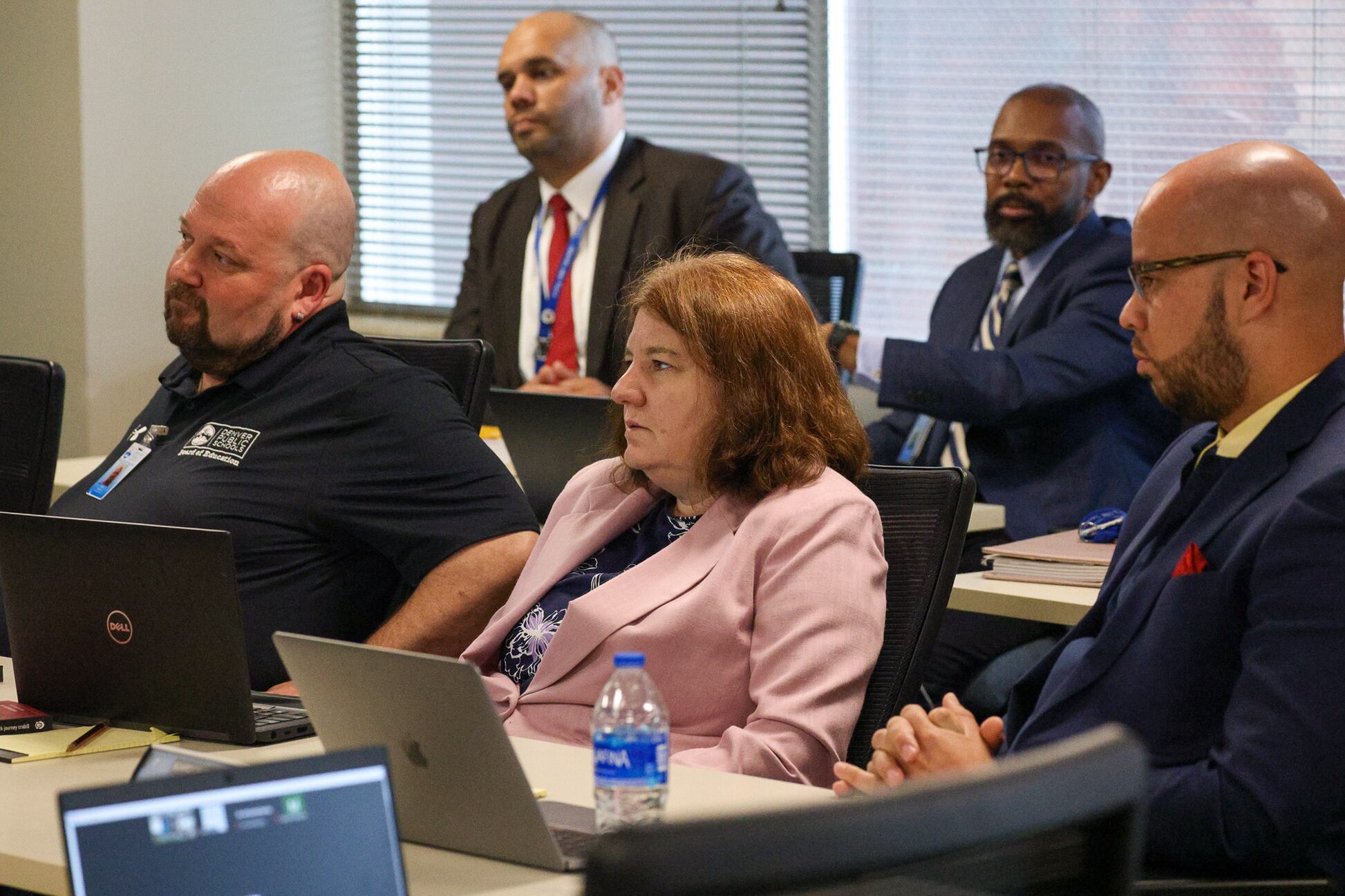 Denver school board members listen during a board meeting.