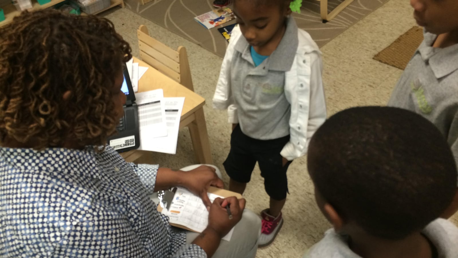 Teacher Marva Bell checks a student’s work.