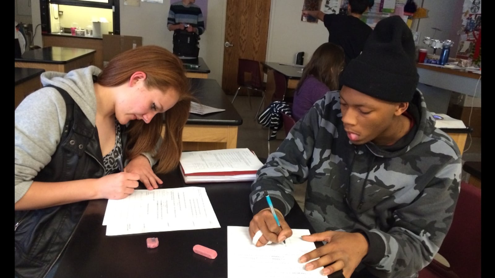Students in a "detracked" East High honors biology class work together prepping for a quiz