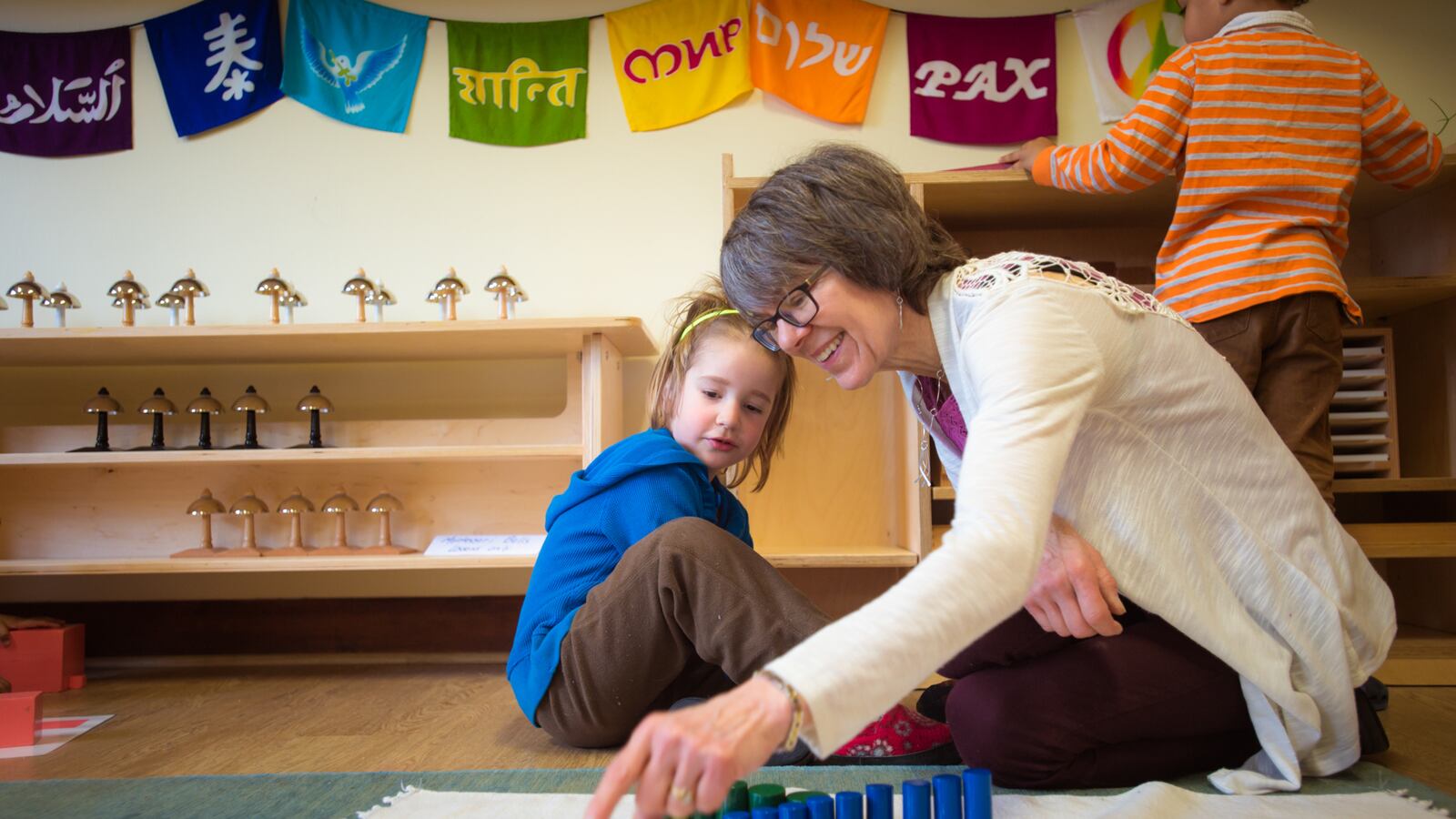 A teacher works with a student at Marigold Montessori School in Haverhill, Mass., which is part of the Wildflower Schools network.