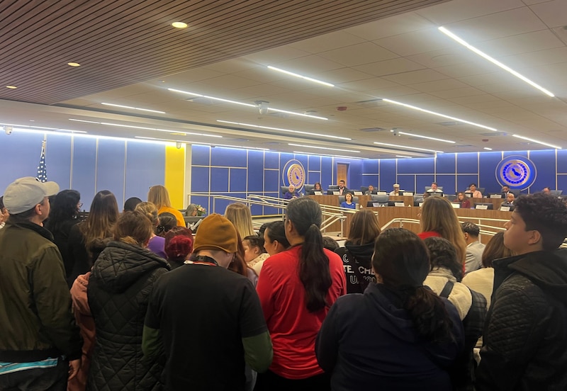 A crowd of people in a board room.