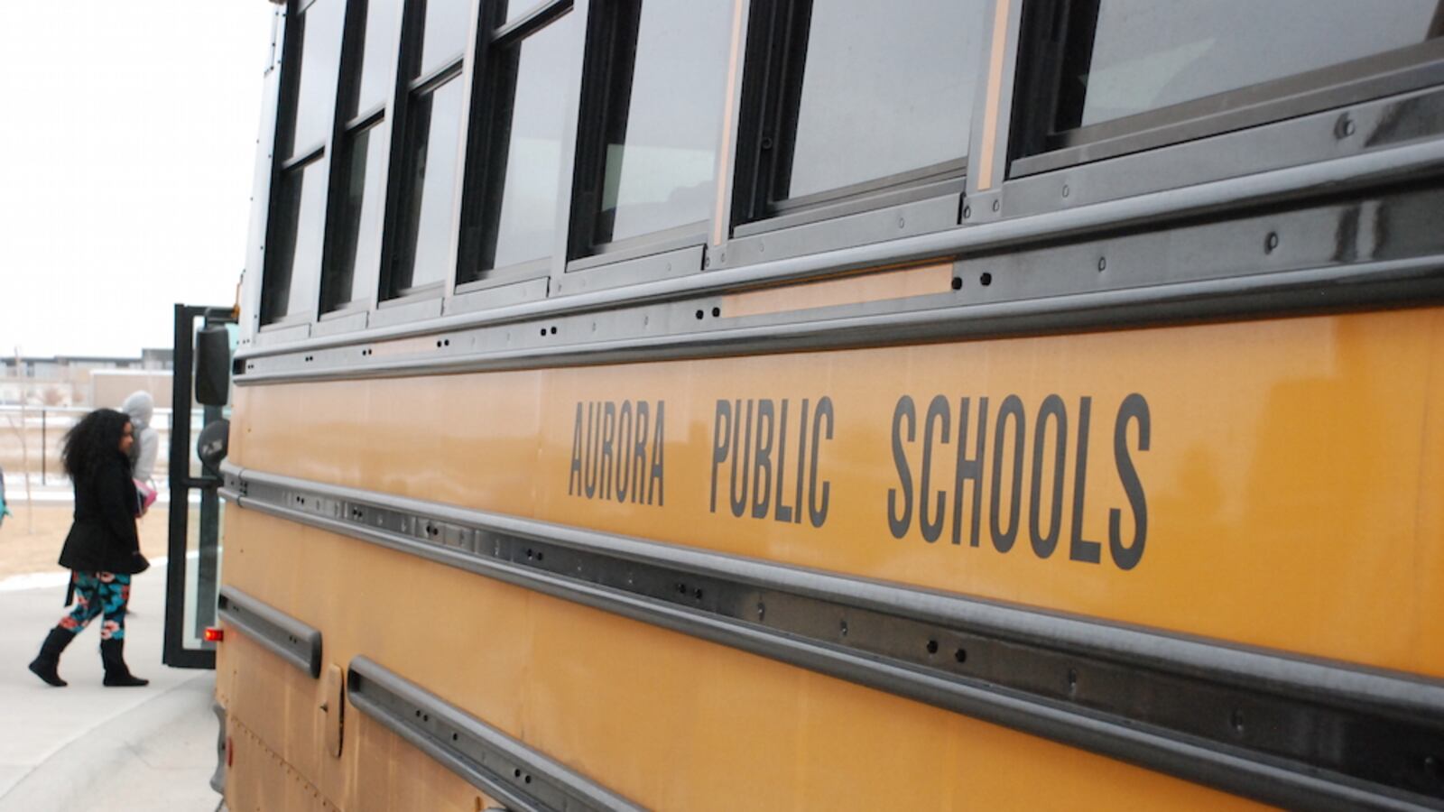 An Aurora Public Schools bus picks up students after school.