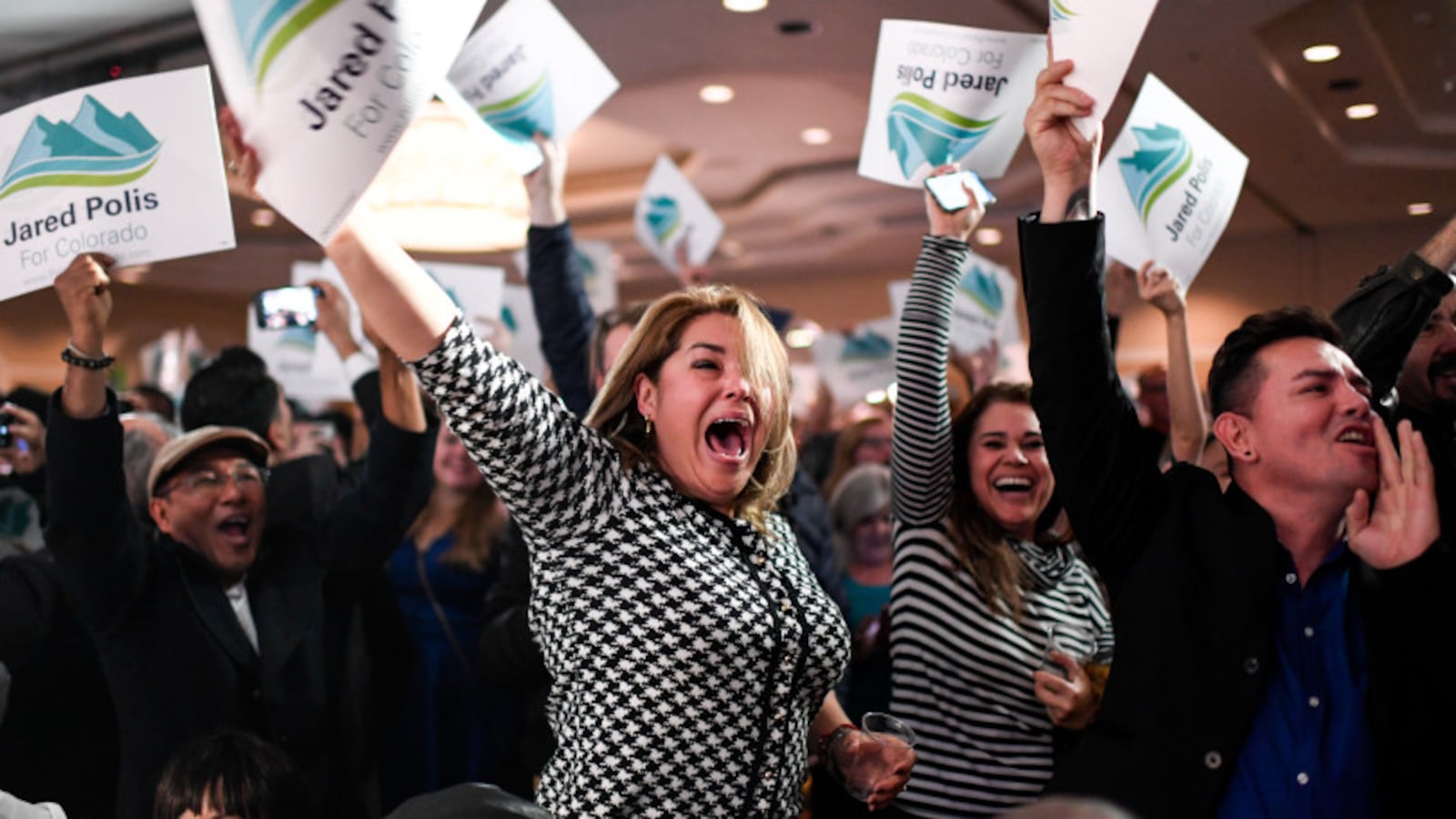 Gabriella Martinez (center) cheers for newly elected governor of Colorado Jared Polis during the Democratic party in downtown Denver on Election Night 2018.