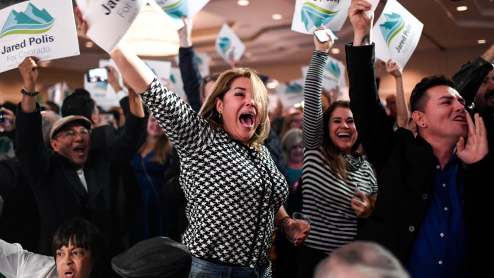 Gabriella Martinez (center) cheers for newly elected governor of Colorado Jared Polis during the Democratic party in downtown Denver on Election Night 2018.