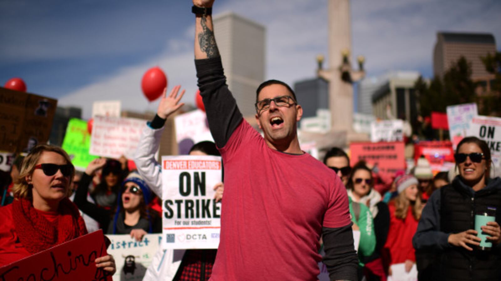 DJ Bruen, a teacher at Johnson Elementary School, gathers with other teachers and their supporters at a rally in Civic Center Park on the second day of the Denver teacher strike.